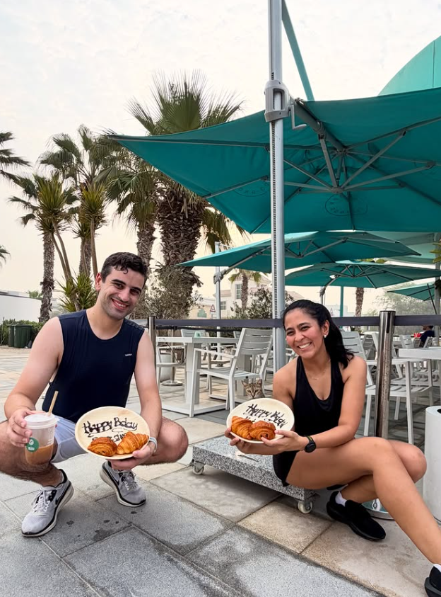 Two Croissant Run Club members celebrating with croissants and coffee